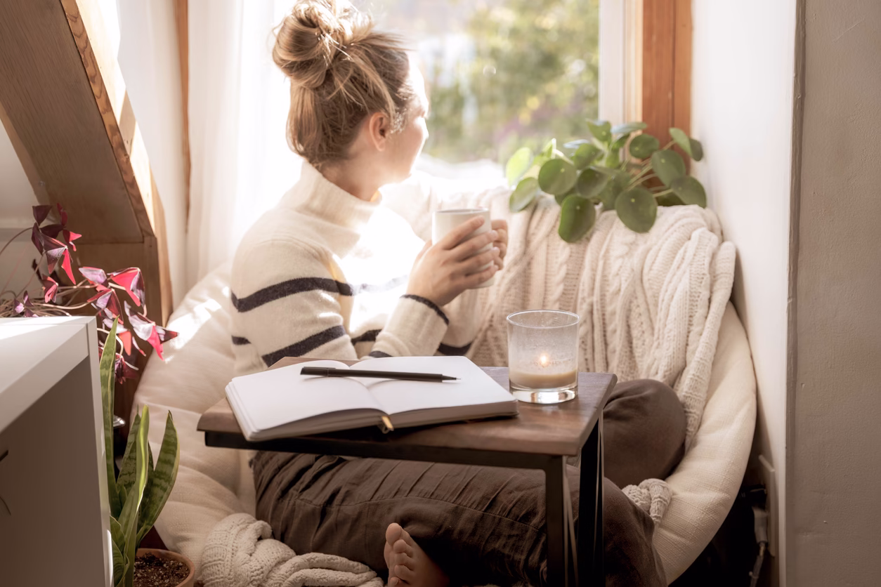 Woman reflecting quietly by a window during divorce healing process Woman reflecting quietly by a window during divorce healing process